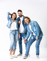 Stylish young people in jeans clothes on white background