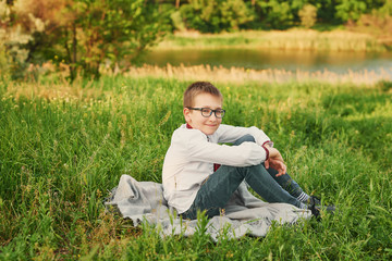 Obraz premium Ukraine's Independence Day. Child boy in an embroidered shirt in field. Ukraine in field. Child kozak. Patriot child.