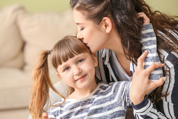 Happy woman with little adopted girl at home