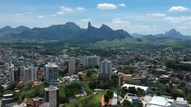 Aerial view over the buildings on a Brazilian small town. View of Pedra do Itabira and Frade e a Freira rock on Cachoeiro do Itapemirim.