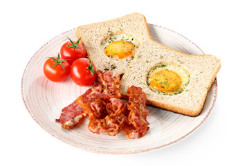 Plate with tasty fried eggs, bacon, toasts and tomato on white background