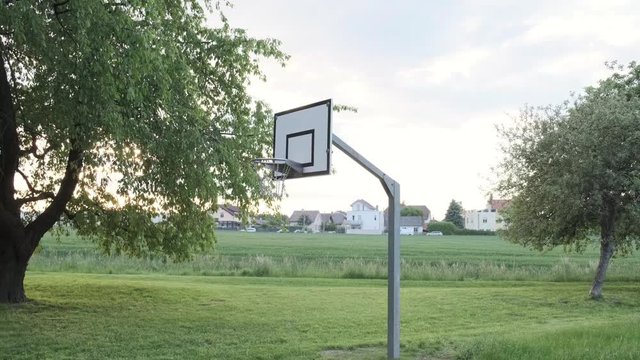 Moving away from a basketball hoop in slow motion