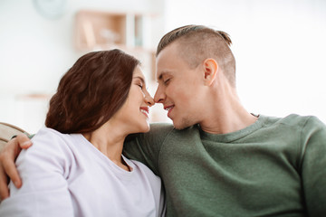 Fototapeta premium Adorable loving couple resting at home