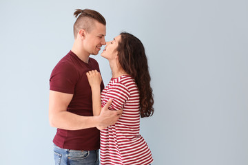 Adorable loving couple on grey background