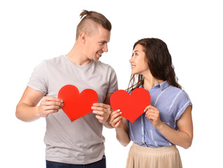 Fototapeta na wymiar Adorable loving couple with paper hearts on white background