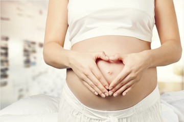 Fototapeta na wymiar Close-up of cute pregnant belly