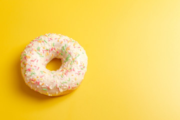 Obraz na płótnie Canvas white donut on yellow background top view copy space