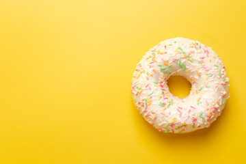 Fototapeta na wymiar white donut on yellow background top view copy space