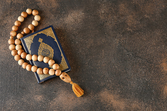 Muslim beads and Koran on grunge background