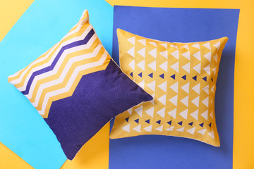 Soft pillows on color background