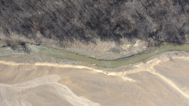Polluted river from mining drainage 4K aerial video