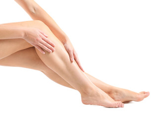 Legs of beautiful young woman after depilation on white background