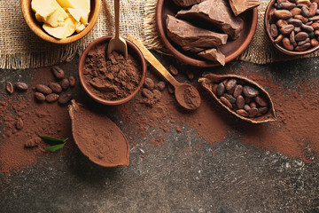 Composition with different cocoa products on dark background
