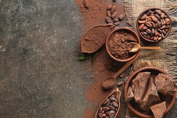 Composition with cocoa powder and chocolate on dark background
