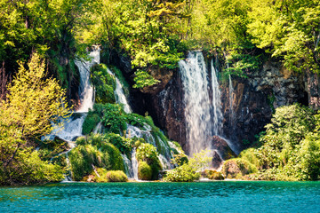 Beautiful morning scene of Plitvice National Park. Colorful spring view of green forest with pure water lake and waterfall. Great countryside view of Croatia, Europe. 