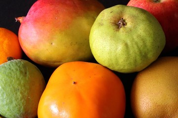 Closeup of Tripical fruits against black background - tropical still life,Fresh and healthy nutrition.