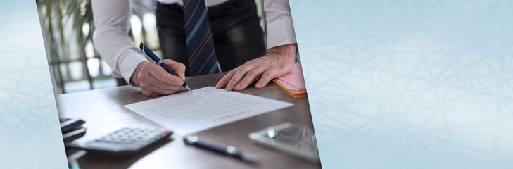 Businessman signing a document; panoramic banner