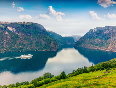 Great summer view of Sognefjorden fjord. Colorful morning scene with Aurlandsvangen village, Norway. Traveling concept background. Artistic style post processed photo.