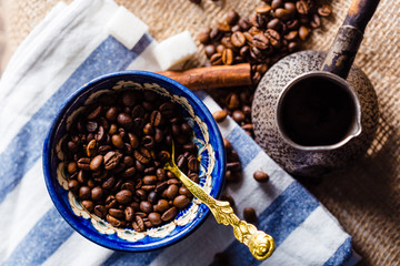 Fresh coffee in cezve on wooden table