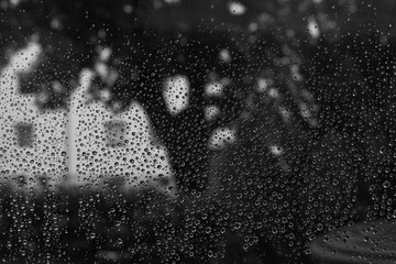 Raindrop on a window as a closeup in b&w