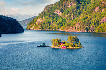 Magnificent summer view with small island with typical Norwegian building on Lovrafjorden flord,...