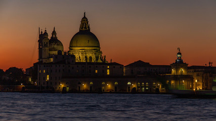Fototapeta na wymiar Classic sunset Venice on the Grand Canal near the Basilica of Santa Maria della Salute, Venice. Romance, travel concept