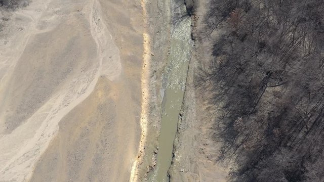 Pyrite waste on river coastal area 4K aerial video