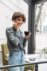 Lovely young girl wearing wireless earphones