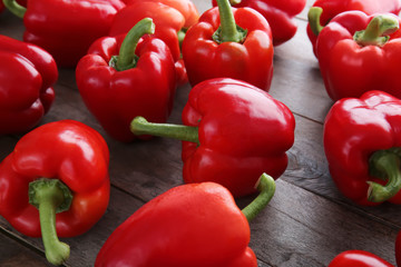 Ripe red peppers on wooden background