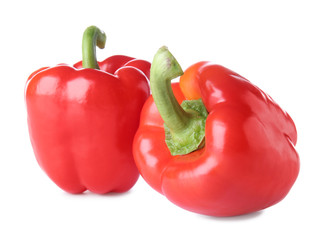 Ripe red peppers on white background