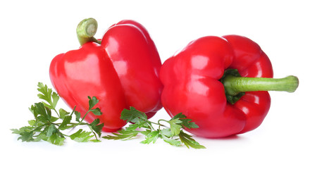 Ripe red peppers on white background