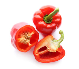 Ripe red peppers on white background