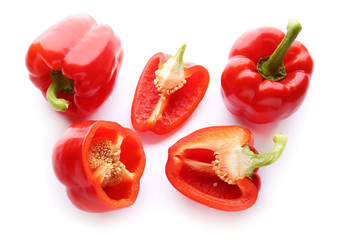 Ripe red peppers on white background