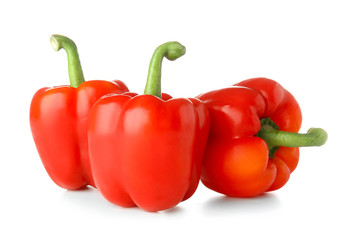 Ripe red peppers on white background