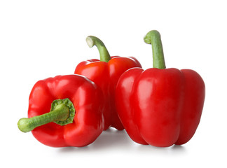 Ripe red peppers on white background