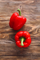 Ripe red peppers on wooden background
