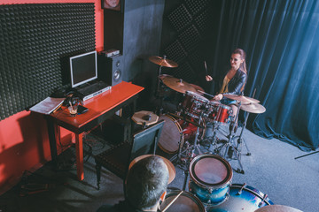 Woman receiving drum lessons from her music teacher