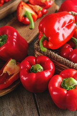 Ripe red peppers on wooden table