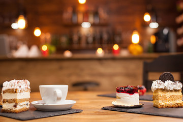 Set of different cakes and desserts freshly baked arranged on wooden table