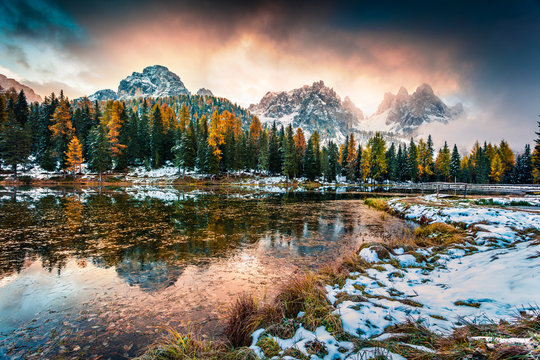 Dramatic sunrise on Antorno lake. Colorful autumn morning in Dolomite Alps, Province of Belluno, Italy, Europe. Artistic style post processed photo.