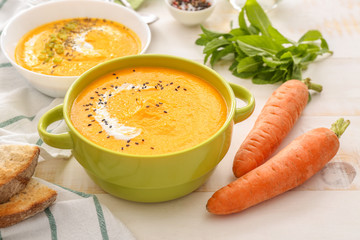 Pot of tasty cream soup on table