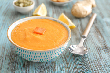 Bowl of tasty cream soup on table