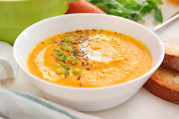 Bowl of tasty cream soup on table