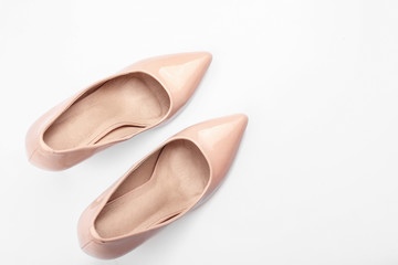 Pair of stylish high-heeled female shoes on white background