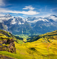 Fototapeta premium Picturesque summer view from the top of Grindelwald First cableway. Schreckhorn mountain in the morning mist, Grindelwald village location, Swiss Bernese Alps, Switzerland, Europe.