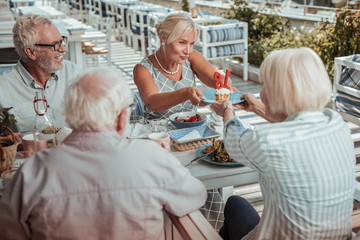 Cheerful bearded male person looking at his wife