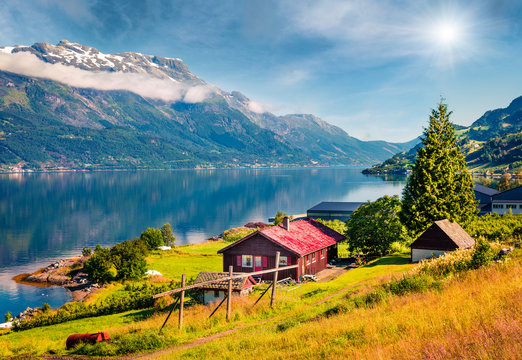 Sunny summer scene in Lofthus village, Hordaland county, Norway. Great morning view of Hardangerfjord fjord. Beauty of countryside concept background.
