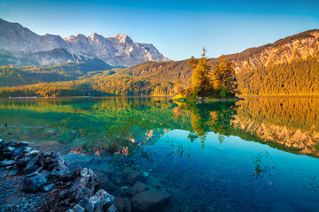 Colorful summer sunrise on the Eibsee lake with Zugspitze mountain range. Picturesque outdoor scene...