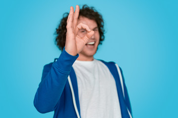Blurred guy showing zero gesture - obrazy, fototapety, plakaty