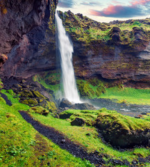 Colorful morning view from the middle of Kvernufoss waterfall. Majestic summer scene of south Iceland, Europe. Beauty of nature concept background.